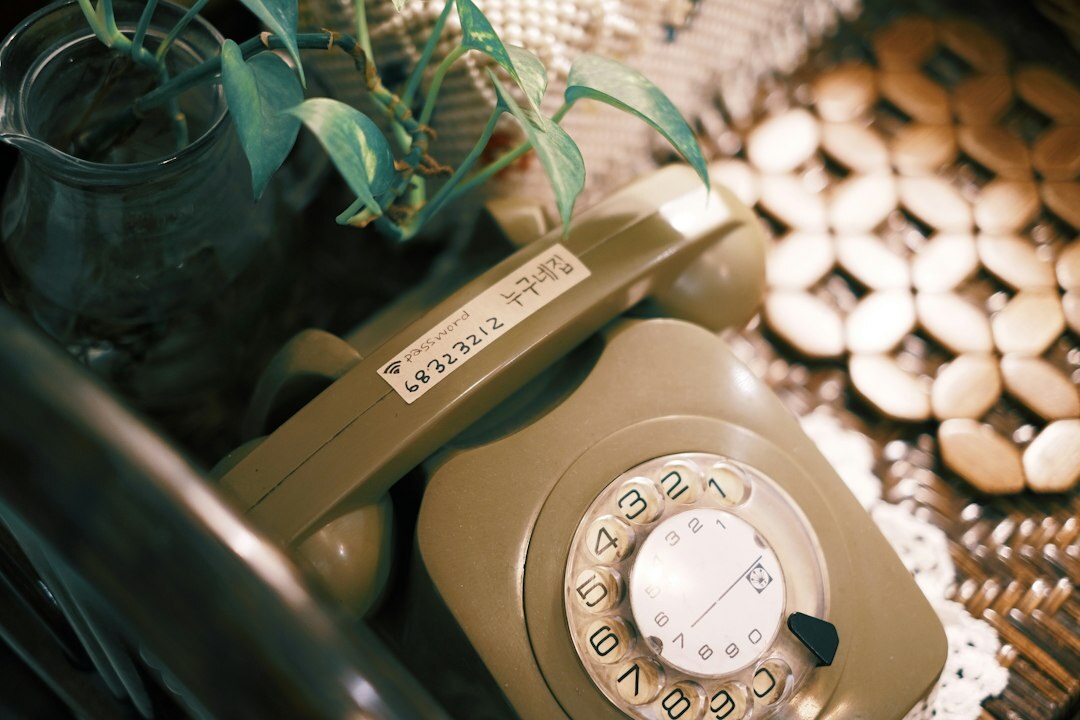 Vintage rotary telephone and stack of letters on a desk
